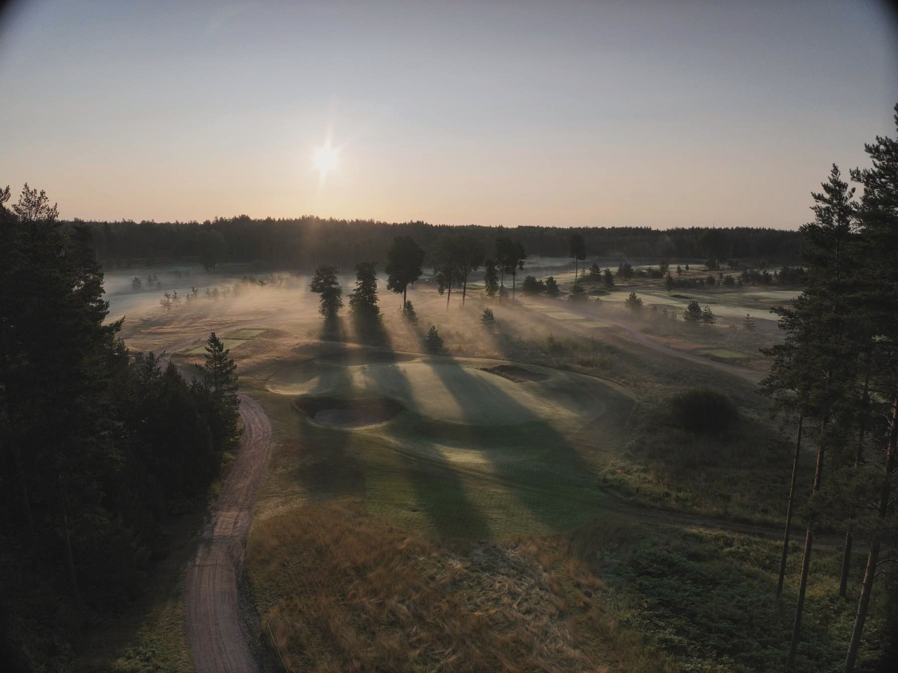 Long dawn shadows across the course