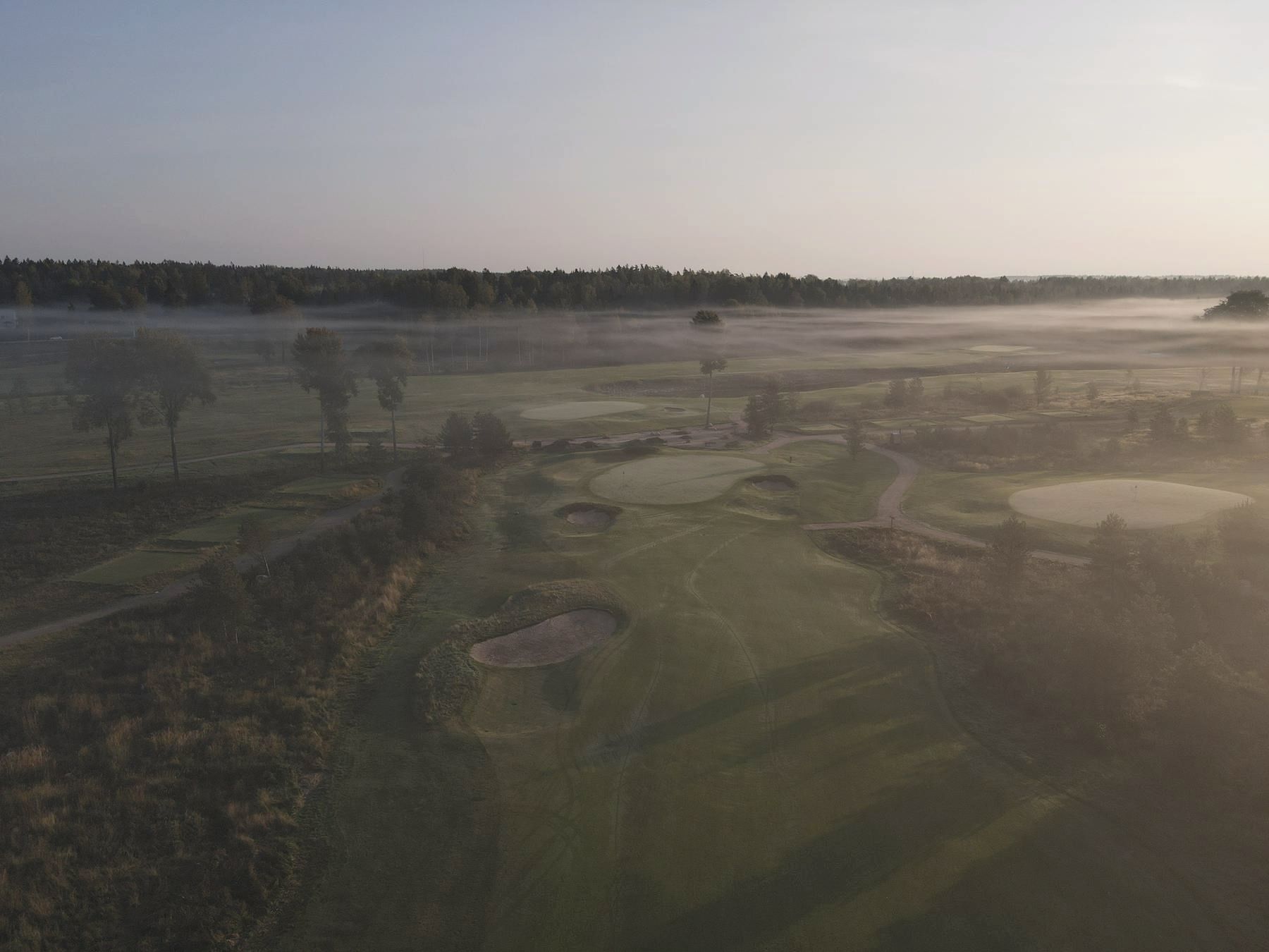 Mist lifting off the greens