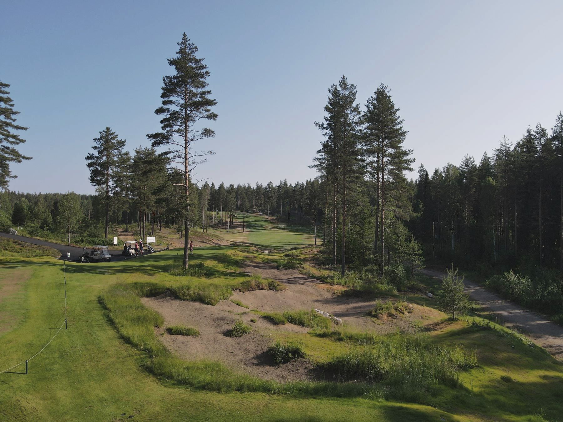 Summer aerial of a forest-lined fairway
